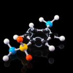 3D molecular model depicting a chemical compound with colorful atoms on a black background