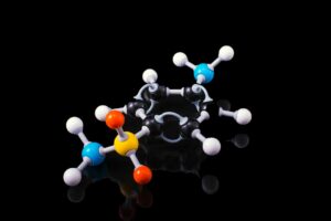 3D molecular model depicting a chemical compound with colorful atoms on a black background