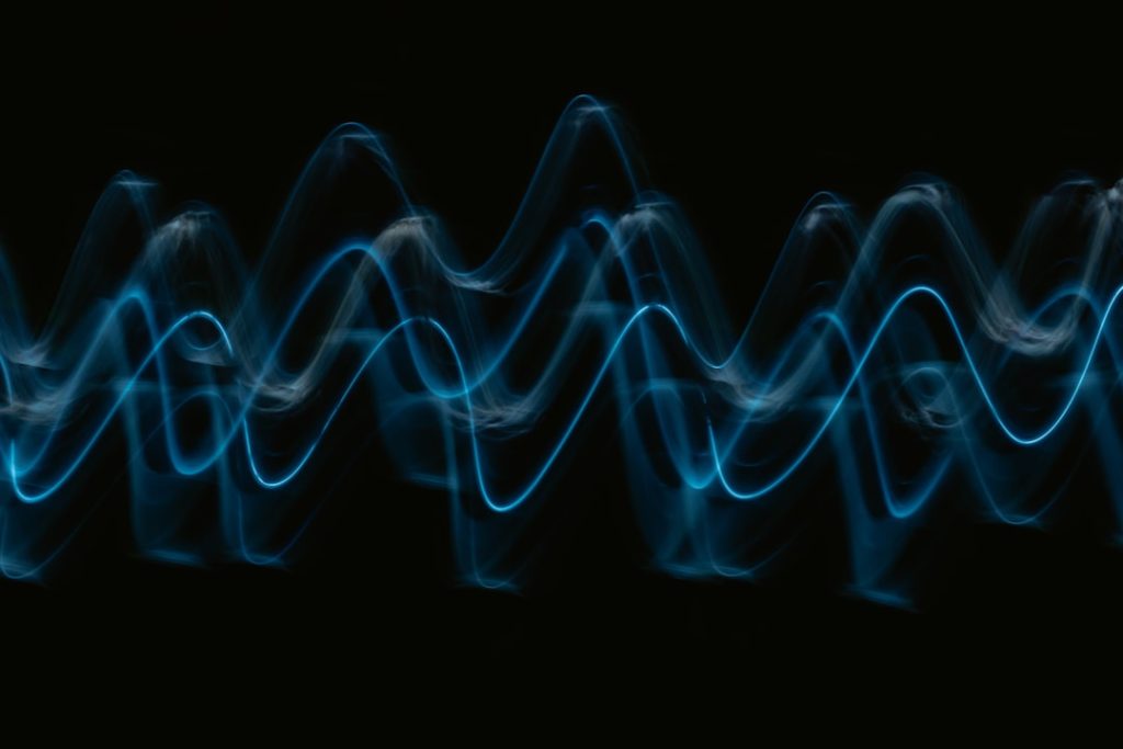 abstract visualization of sound waves in blue light against a black background